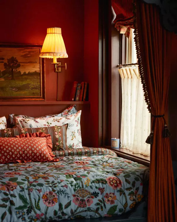 Colorful floral bedding in a warmly lit bedroom