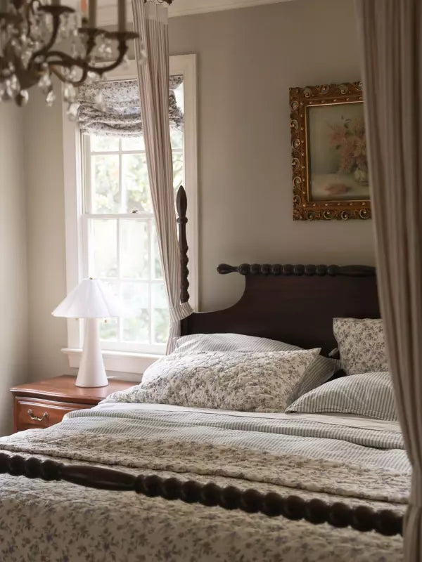 A layered bedroom with neutral patterned bedding