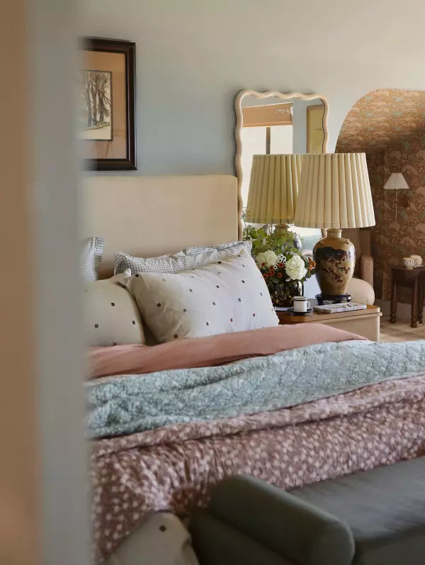 A cozy bedroom with layered soft bedding